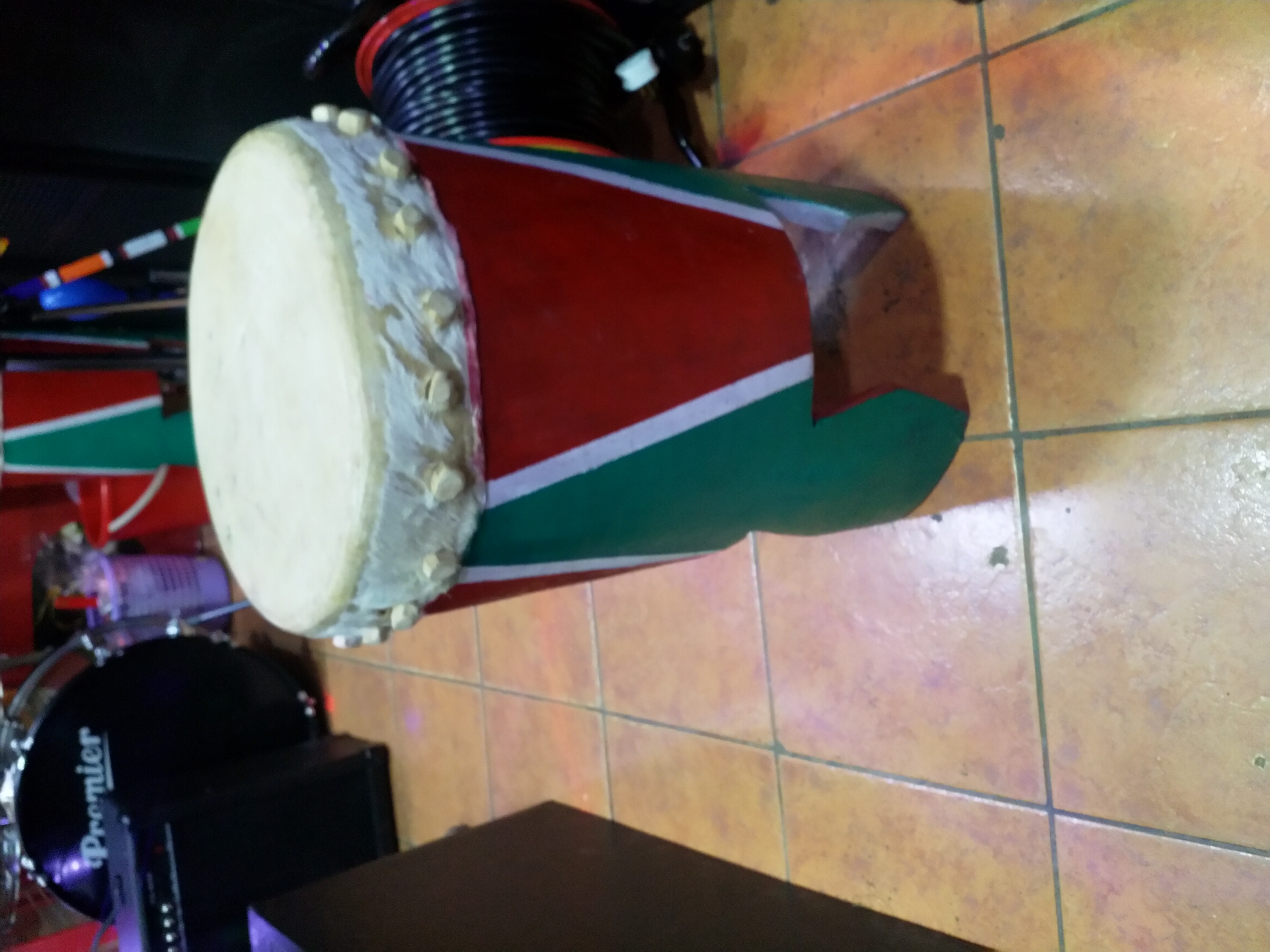 "Handcrafted Mabumbumbu traditional drum from Kenya featuring a single-headed cylindrical wooden body with animal skin drumhead, producing deep bass tones and used by the Giriama people of the Mijikenda community for cultural ceremonies, traditional dances, and performances. Available at Musicland Music Shop." "Handcrafted Mabumbumbu traditional drum from Kenya featuring a single-headed cylindrical wooden body with animal skin drumhead, producing deep bass tones and used by the Giriama people of the Mijikenda community for cultural ceremonies, traditional dances, and performances. Available at Musicland Music Shop."
