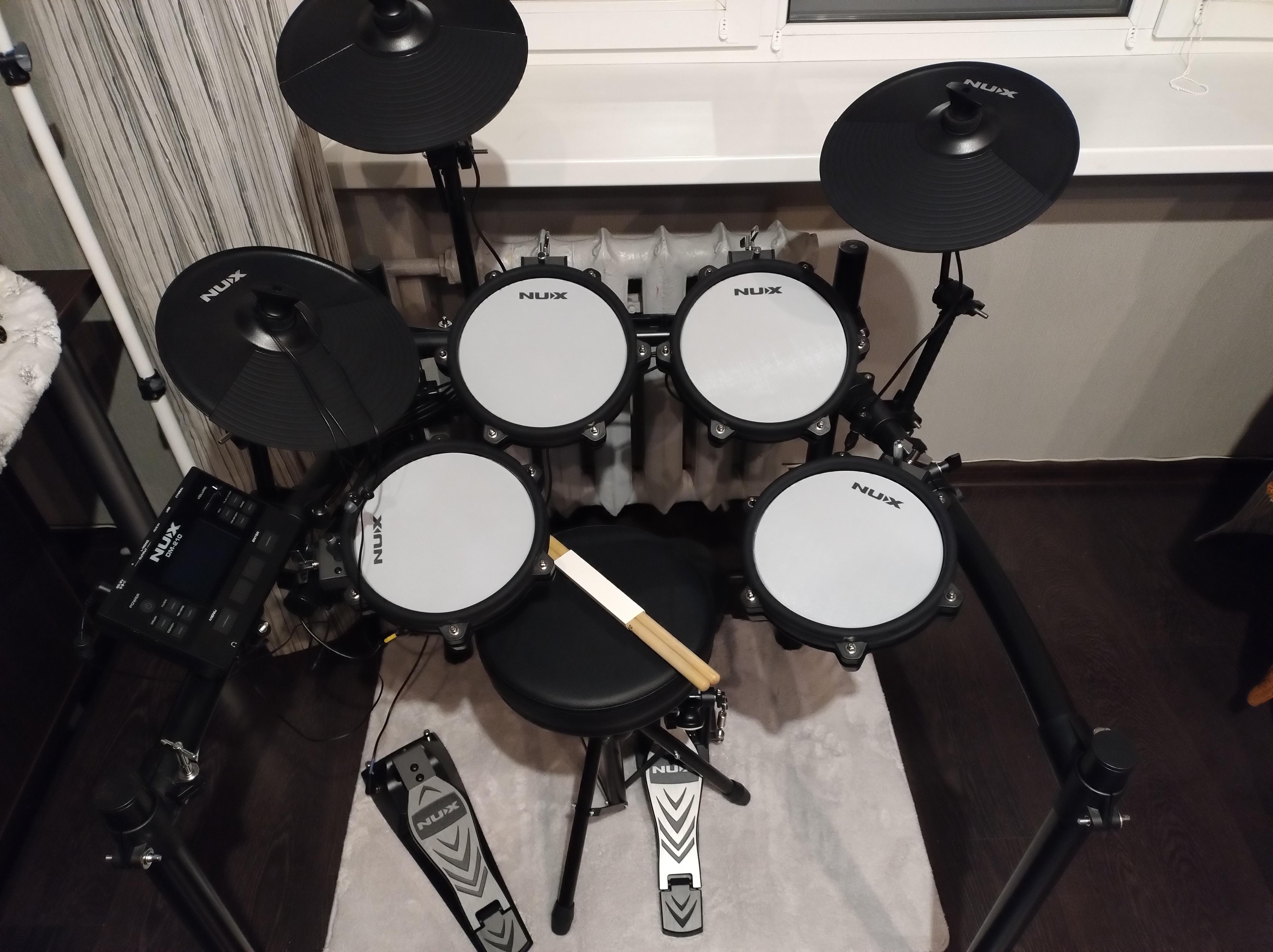 NUX DM-210 all-mesh electronic drum kit with dual-zone mesh pads, Bluetooth audio, USB MIDI, and kick tower available at Musicland Music Shop.
