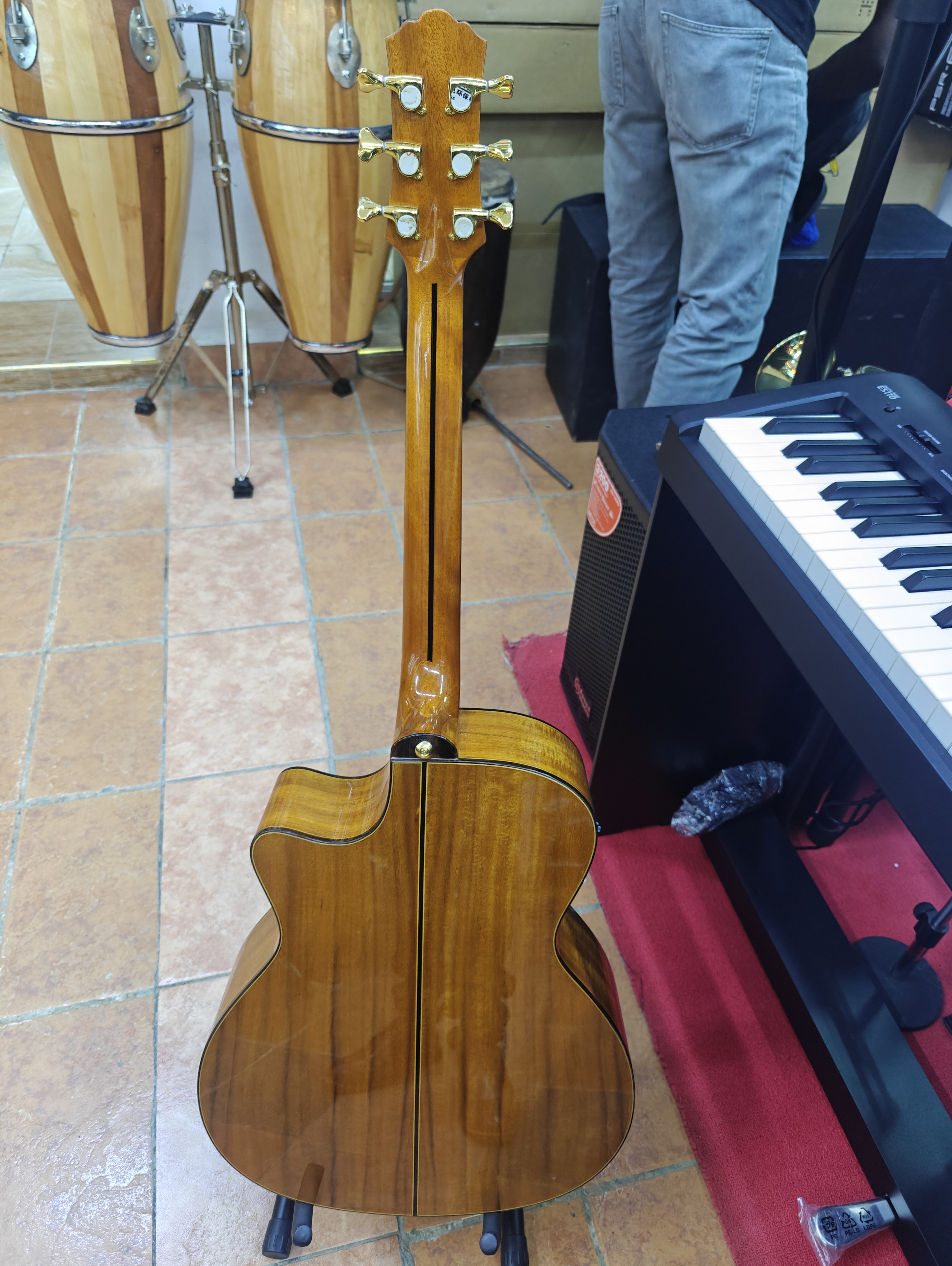 Back view of the Spread Music semi-acoustic guitar with beautifully figured wood back, slim neck, and gloss finish.
