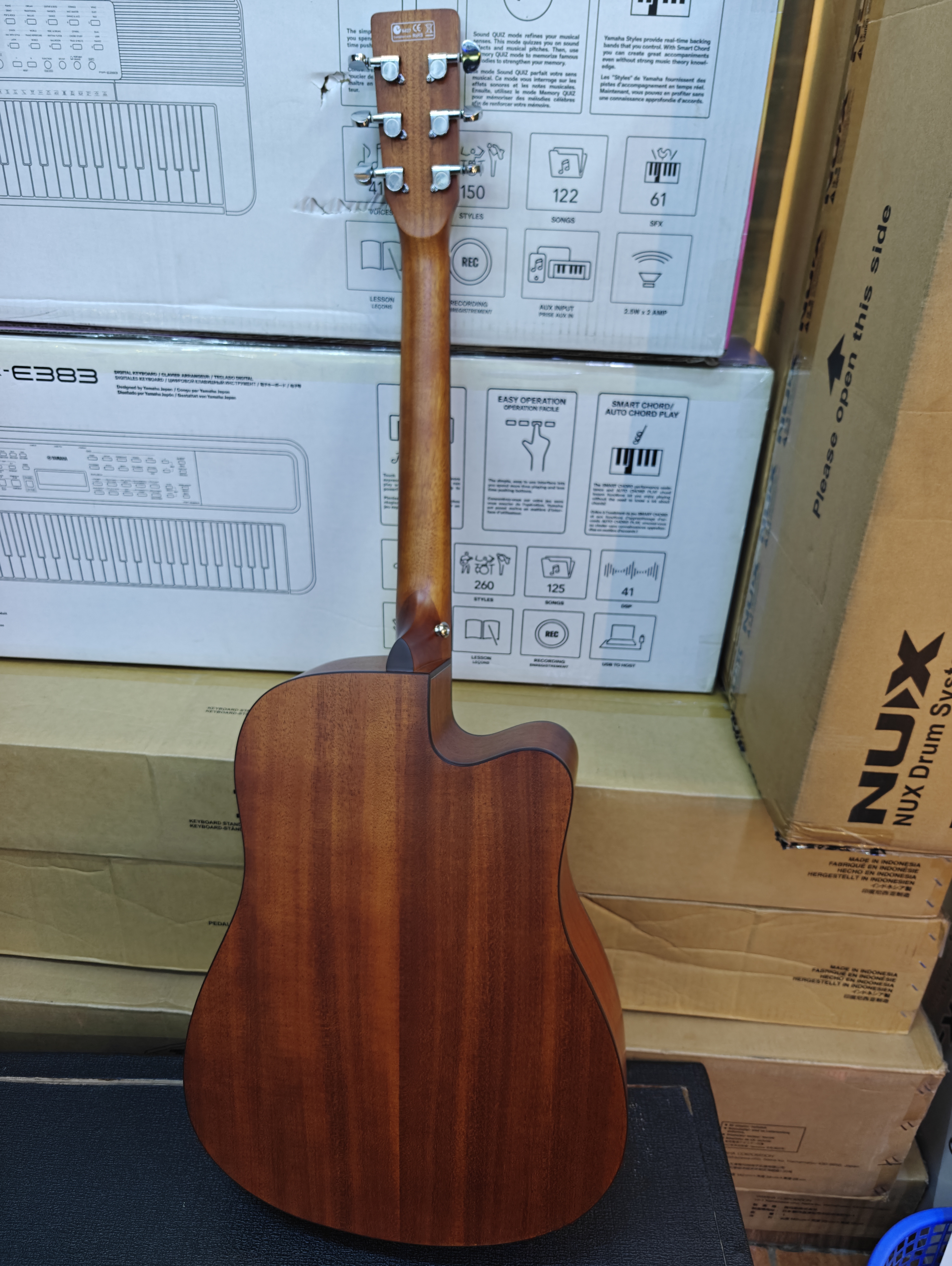 Maxtone 41-inch left-handed semi-acoustic guitar with cutaway body, built-in EQ pickup system, and natural wood finish back side