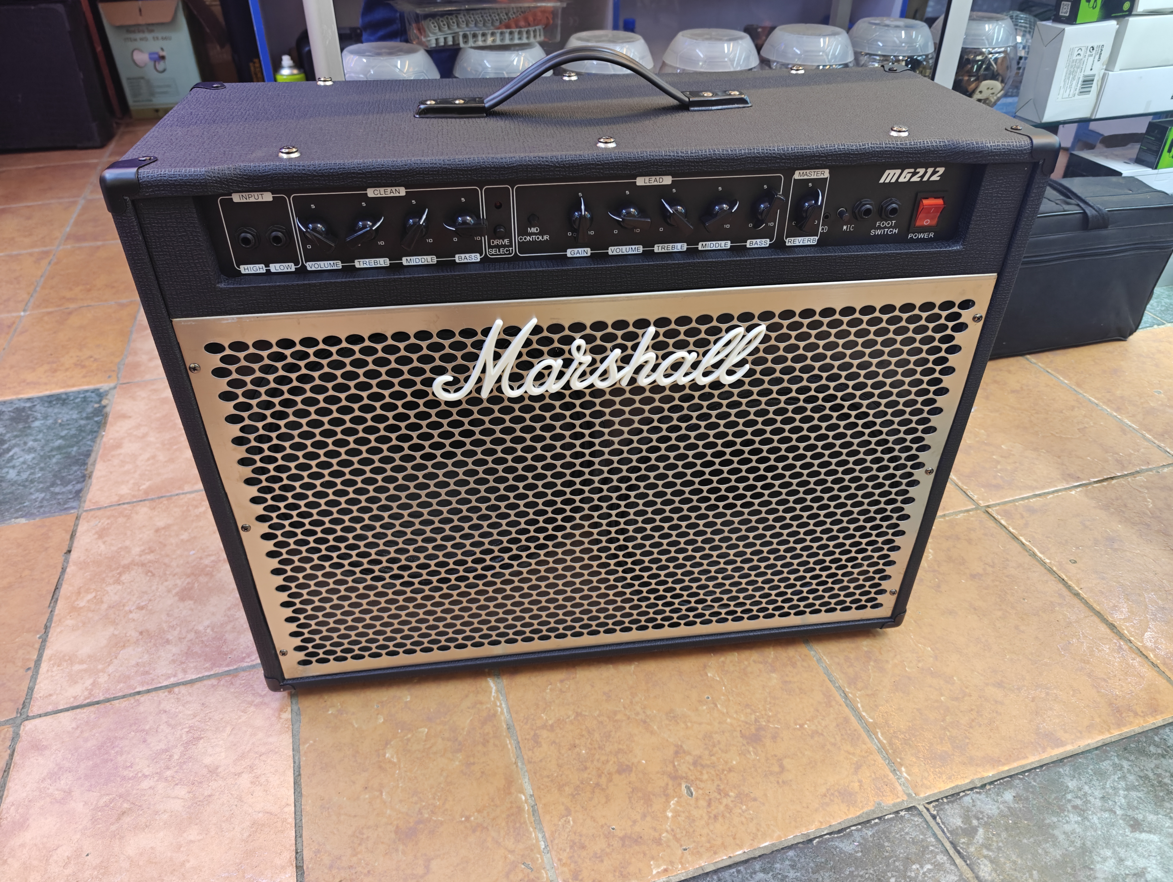 Marshall MG212 guitar amplifier with dual 12-inch speakers, clean and overdrive channels, reverb, microphone input, footswitch input, and classic black cabinet for live performance and practice. Marshall MG212 guitar amplifier with dual 12-inch speakers, clean and overdrive channels, reverb, microphone input, footswitch input, and classic black cabinet for live performance and practice.