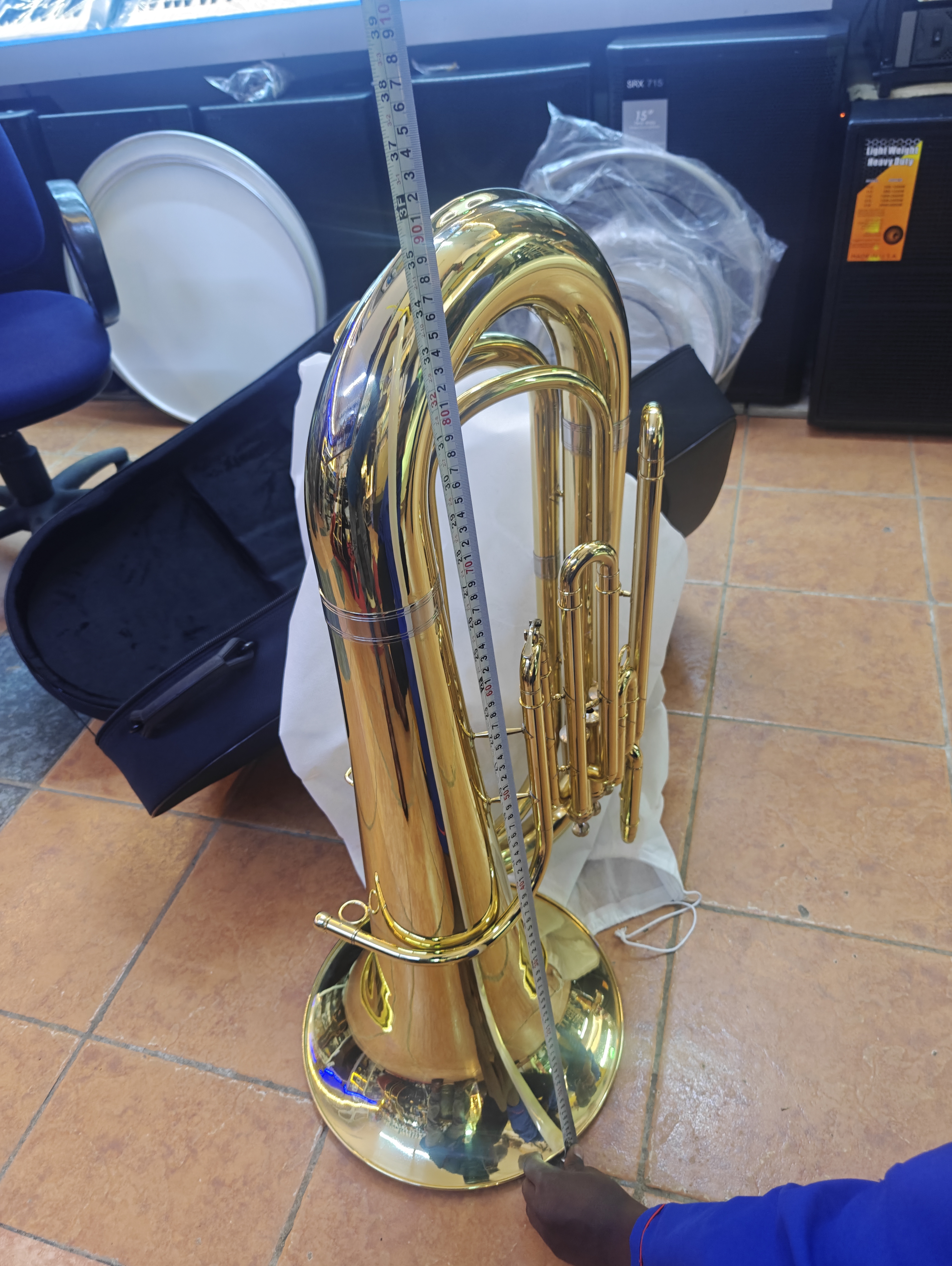 Premier England Bass Tuba with gold lacquer finish and hard case, professional brass instrument for school bands, church orchestras, brass ensembles, and concert performances.