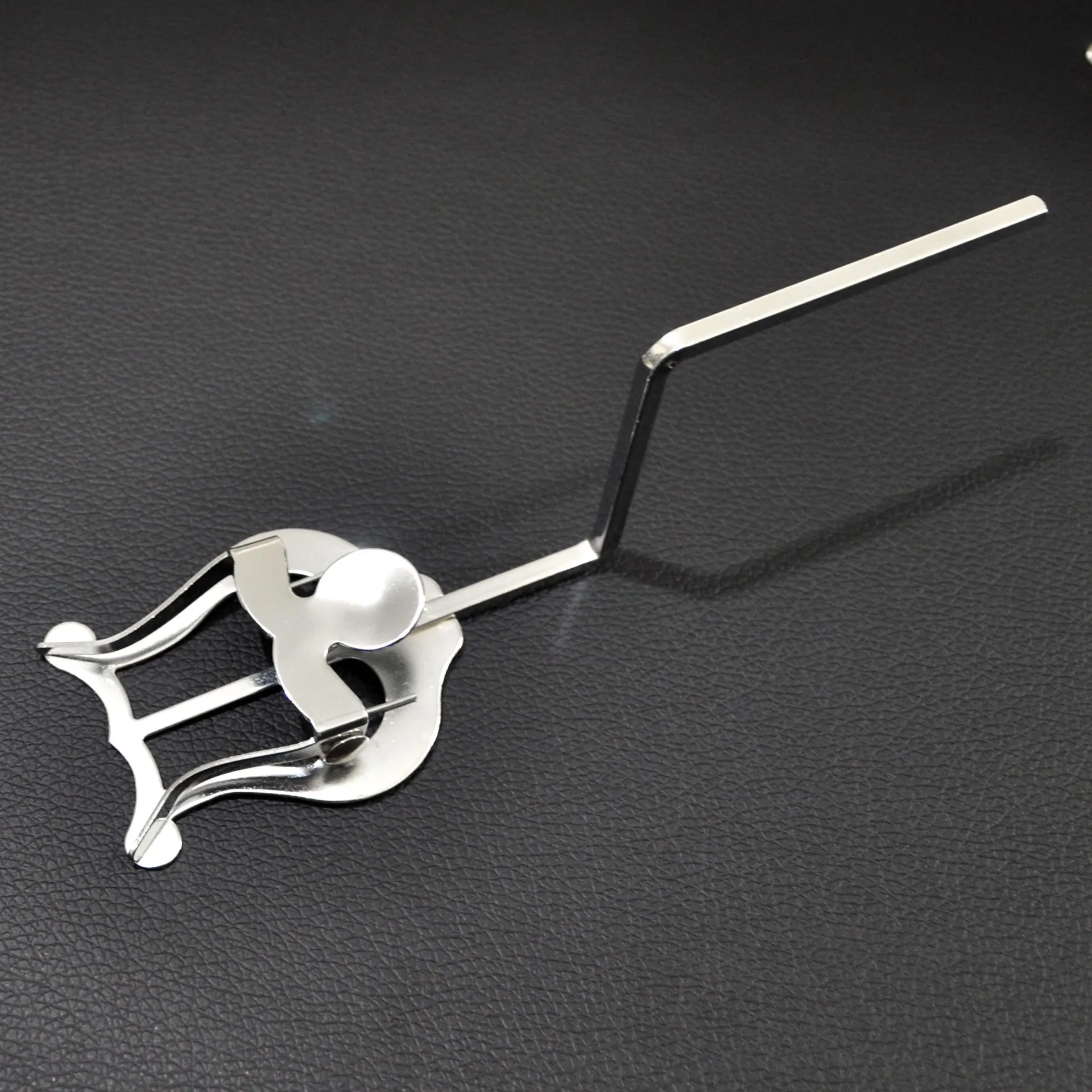 Chrome-plated trombone lyre sheet music holder with spring clip for marching bands and orchestras.